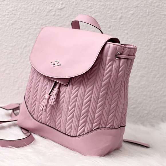 coach elle backpack purple // Leather VSP Consignment Refined pebble leather Inside zip and multifunction pockets Snap closure fabric lining Handle with 3 drop Outside zip pocket Adjustable shoulder straps 11 (L) x 11 (H) x 6 1/4 (W) Style No. Convertible Backpack Coach Purple Backpack